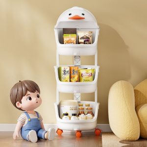 Kệ nhựa đa năng 4 tầng hình vịt đựng đồ chơi và vật dụng cho bé Kệ nhựa hình vịt màu trắng ba tầng, đặt cạnh bé trai, chứa đồ ăn vặt.