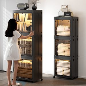 Tủ nhựa gấp gọn đựng quần áo đa năng cửa trong suốt chống bụi Cô gái mở tủ nhựa màu đen, bên trong đựng quần áo gọn gàng.