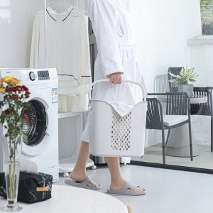 Cận cảnh người cầm giỏ đựng đồ giặt, dễ dàng di chuyển.